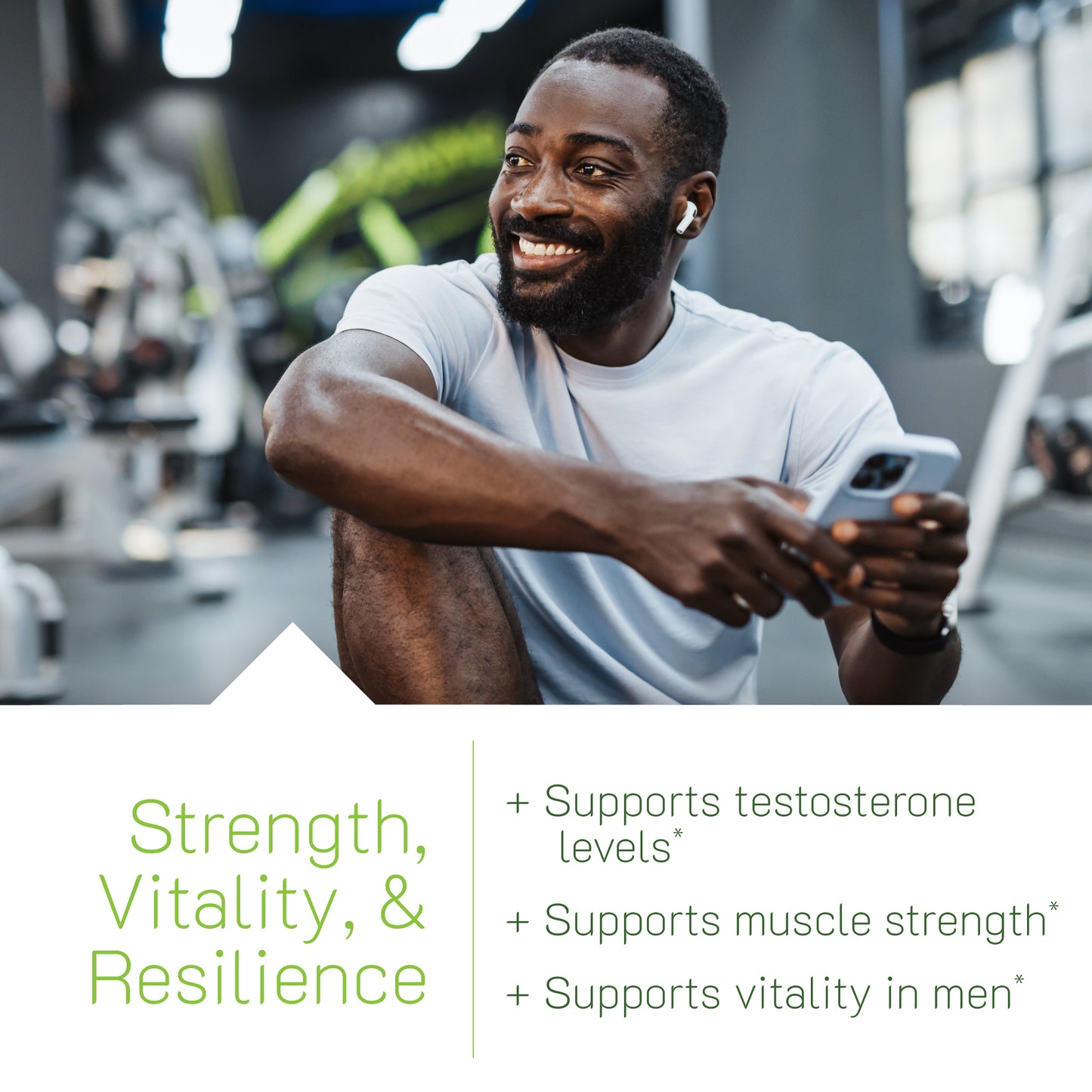 A man smiling in a gym setting while holding a smartphone, with a text block highlighting three key benefits of Testosterone UP Gummies: Supports testosterone levels, supports muscle strength, and supports vitality in men.